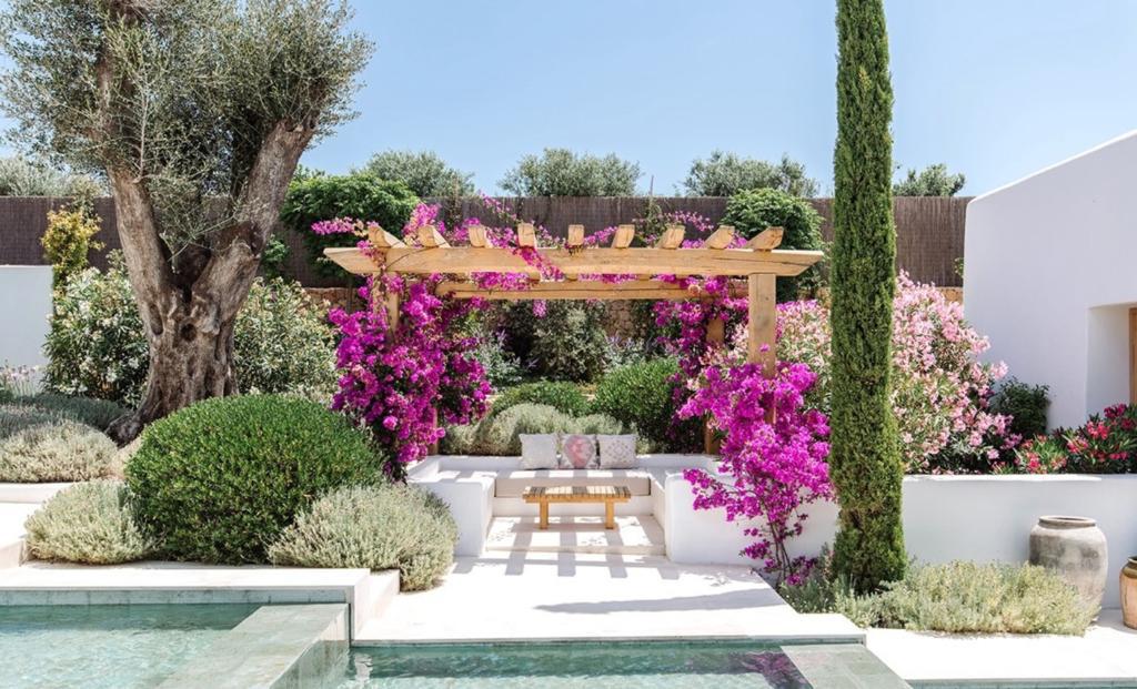 viga_1 Vigas de madera en pérgola exterior rodeada de flores y vegetación